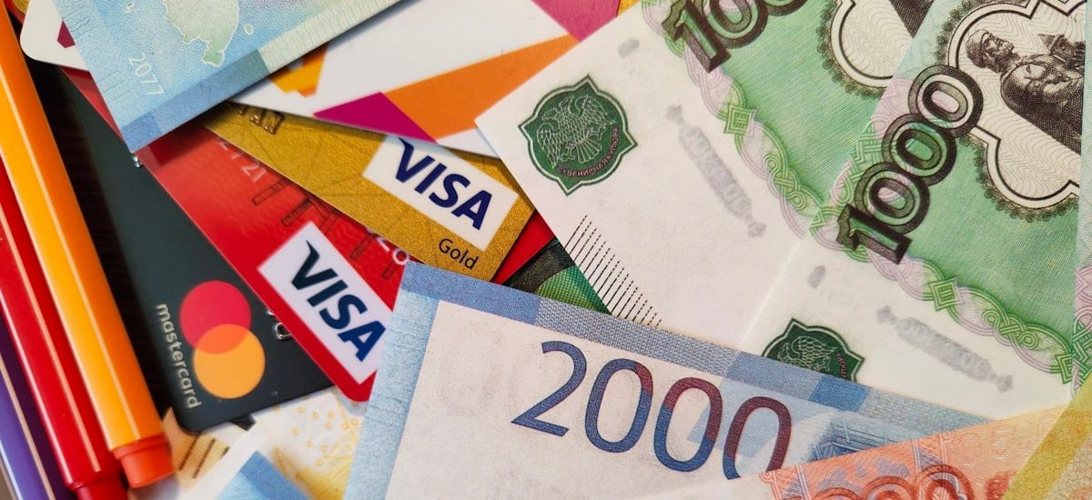 Russian RUR Rubli Roubles paper banknotes and credit cards, closeup shot from above. Free stock editorial photo for blog content, online magazines and other resources covering banking and financial topics